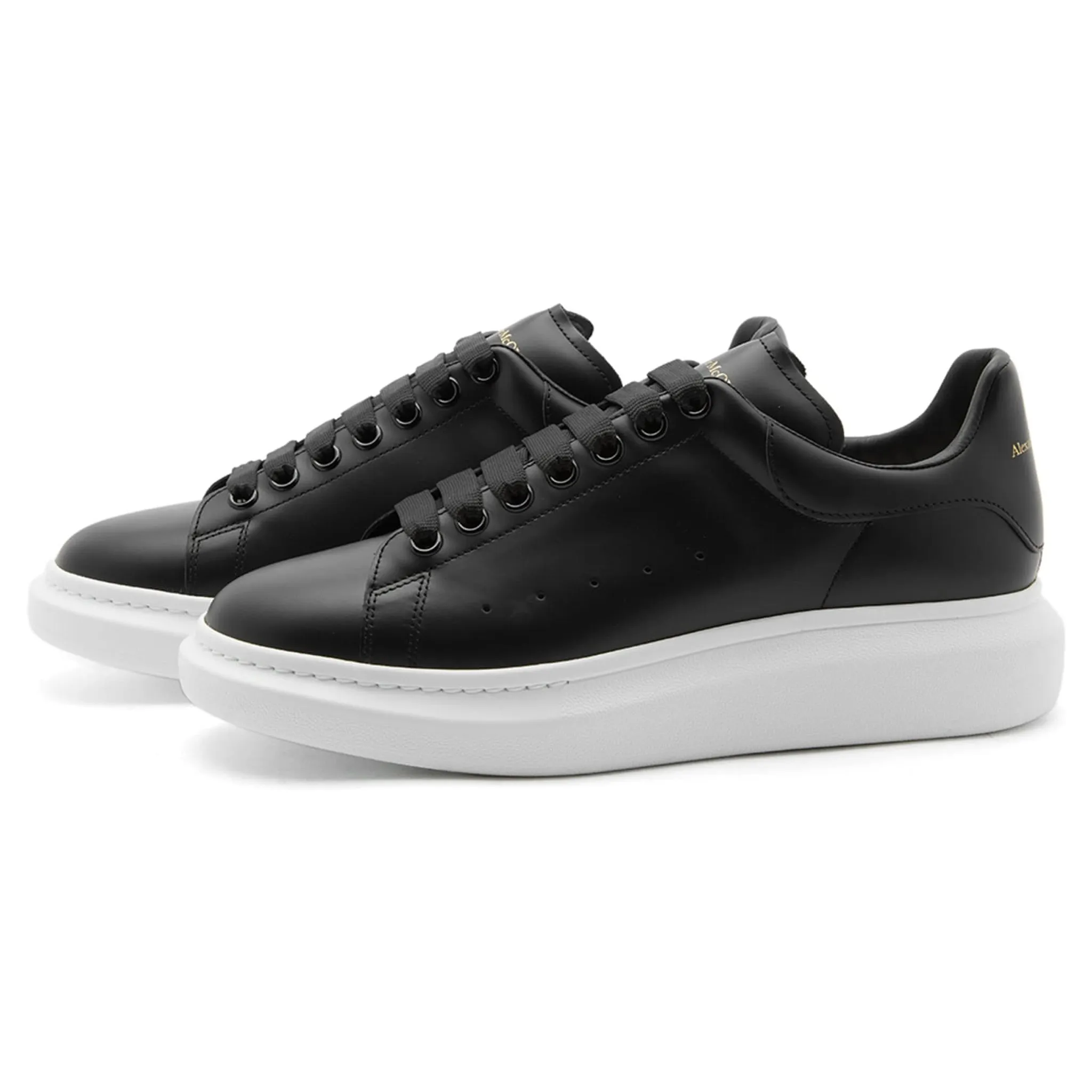 Alexander McQueen black sneaker with raised sole.