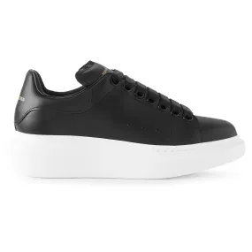 Alexander McQueen black sneaker with raised sole.