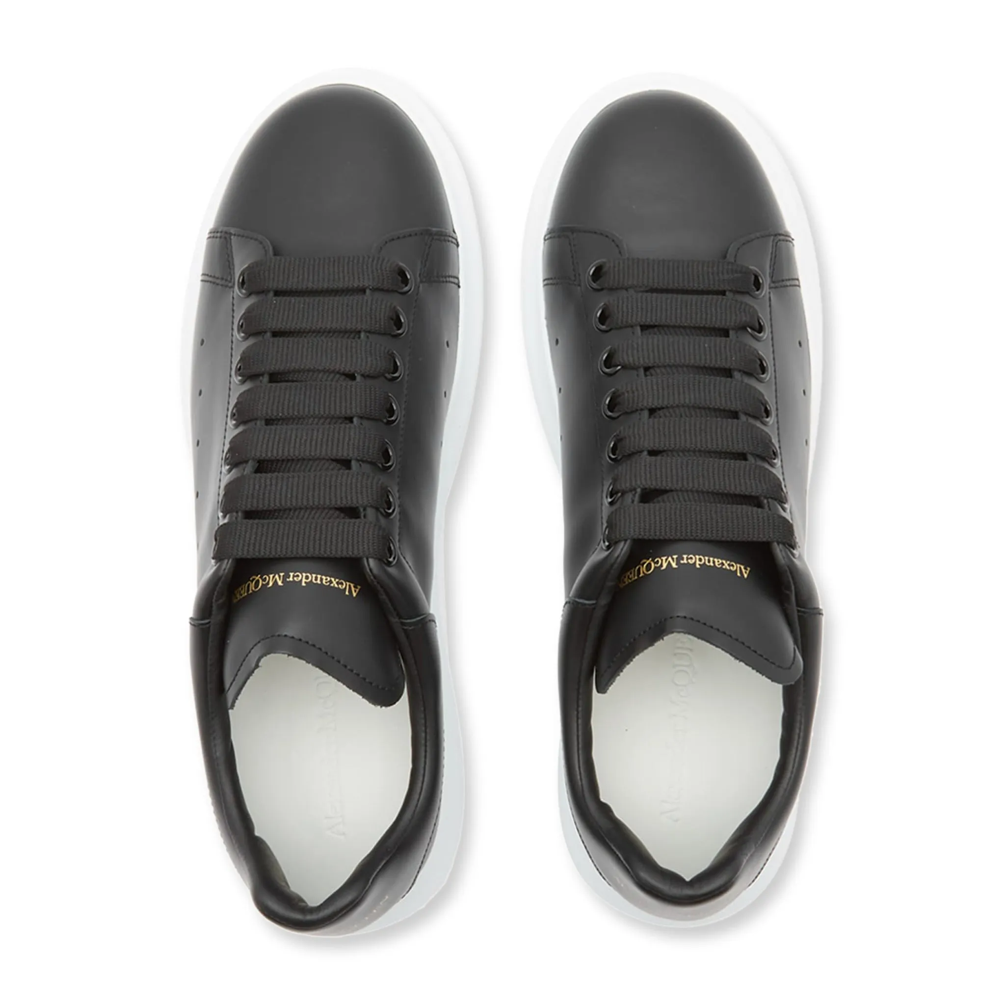 Alexander McQueen black sneaker with raised sole.