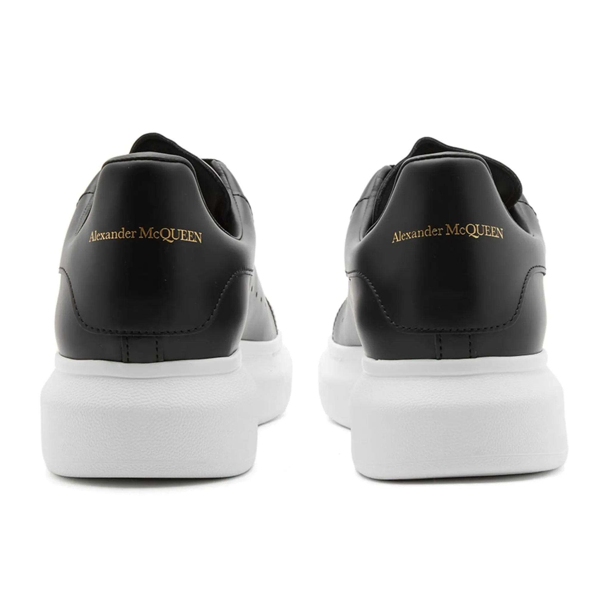 Alexander McQueen black sneaker with raised sole.