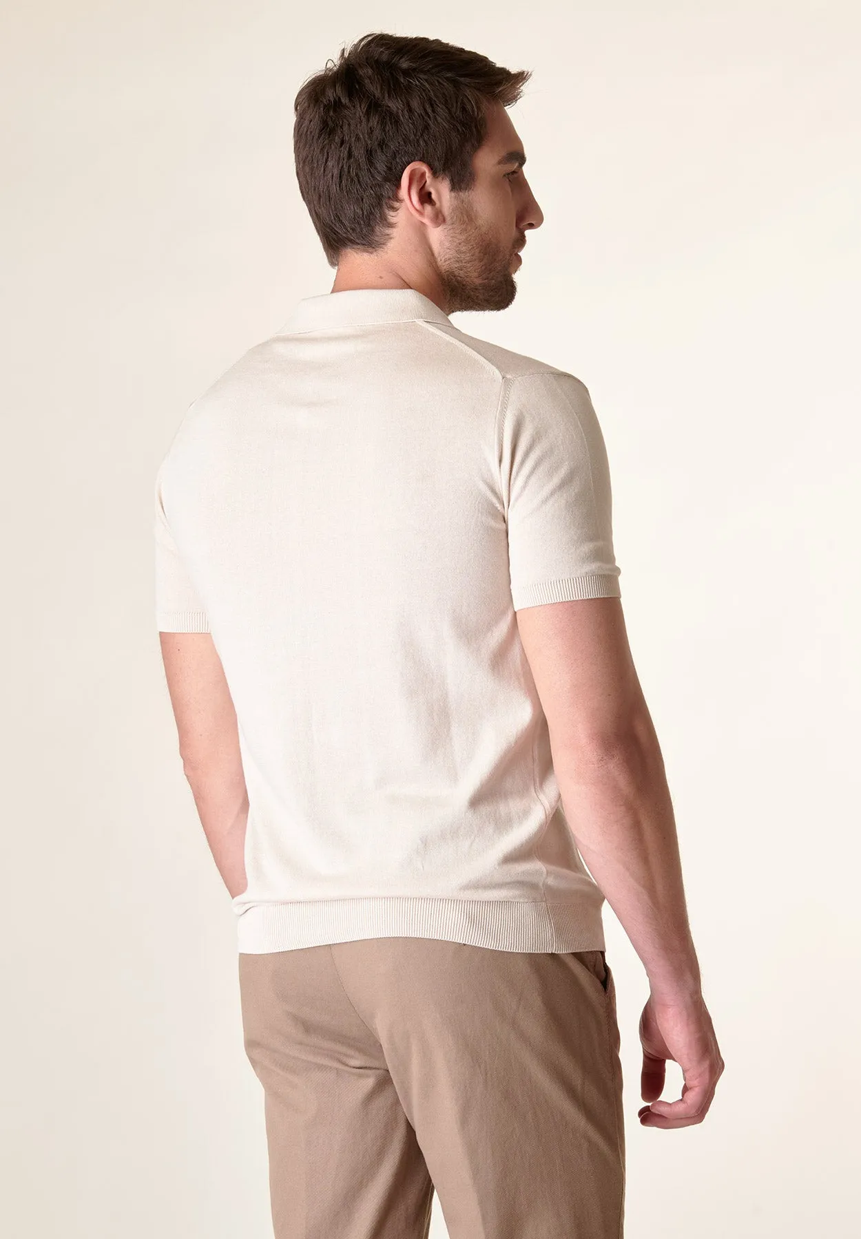 Beige derby collar buttonless polo shirt.