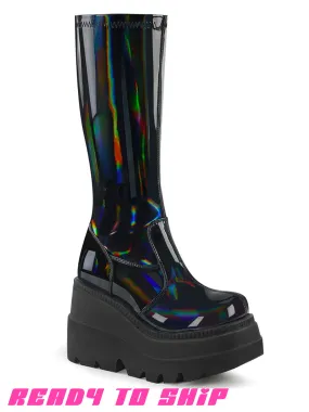 Demonia Shaker 65 Boots | Holo Black Patent | Shop Now