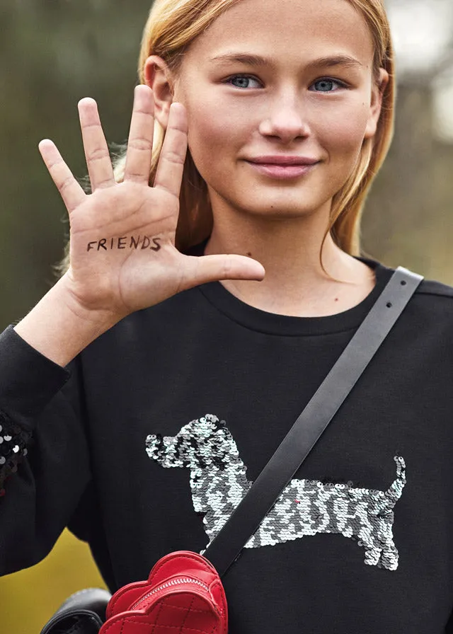 Teen girl black pullover.