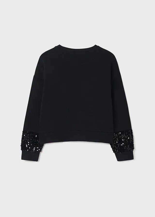 Teen girl black pullover.